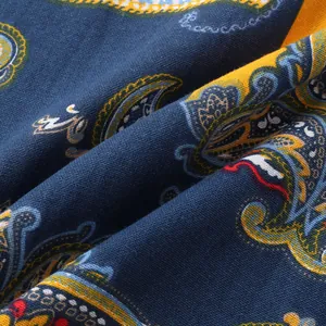Macro detail shot showing the weave and paisley pattern of the navy blue men's shirt fabric