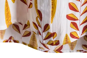Detail shot showing neat stitching and leaf print on a casual short-sleeved shirt hem
