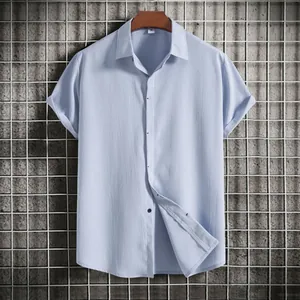 Detail view of men's light blue short sleeve shirt with textured fabric and button collar