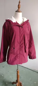 Detailed view of wine red winter jacket for women with white fleece lining on a mannequin