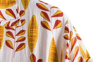 Close-up detail of men's short sleeve shirt with yellow and brown leaf pattern