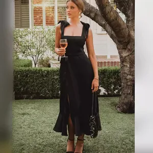 Elegant black French midi dress with bow shoulder straps and side slit for parties.