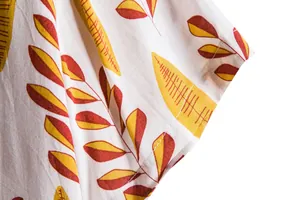 Close-up detail of short sleeve cuff on men's white casual shirt with yellow leaf pattern