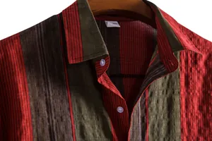 Close-up of the collar and textured vertical striped fabric on a casual men's shirt.
