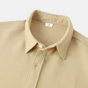 Close-up of men's casual shirt collar showing waffle-knit fabric texture and S tag