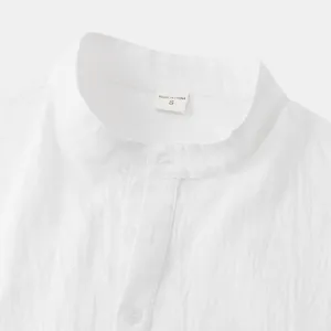 Detail view of a white men's cotton linen shirt featuring a mandarin collar and size S tag