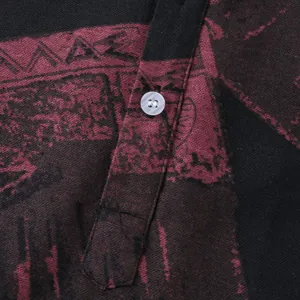 Close-up view of button and printed fabric texture on men's short sleeve shirt