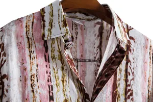 Close-up of men's casual short-sleeve shirt with pink and brown abstract print details