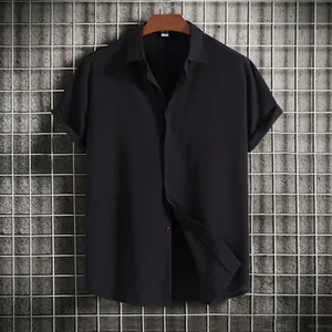 Black short-sleeved button-up shirt for men with textured fabric hanging on hanger