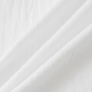 Close-up of breathable white cotton linen fabric texture for summer men's shirt.