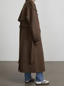Side view of premium long brown wool coat featuring lapel collar and waist belt details