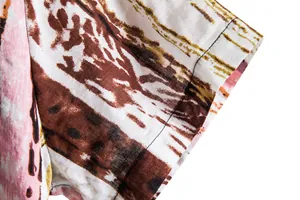 Close-up detail of a floral short-sleeved casual shirt for men showing fabric texture.