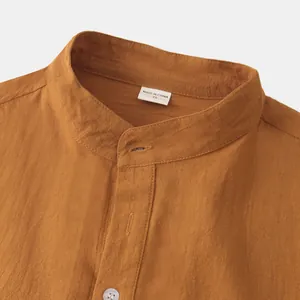 Close-up of men's rust cotton linen shirt featuring a mandarin collar and fabric texture