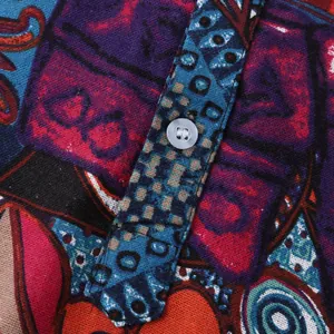 Macro detail of men's casual Hawaiian shirt with ethnic print and white button.