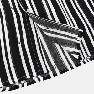 Close-up detail of the hem and stitching on a black and white striped men's casual shirt