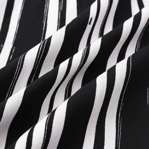 Macro view showing the soft texture and distressed black and white stripes of the shirt.