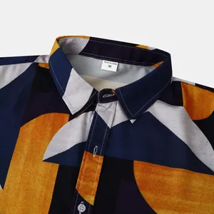 Close-up of men's geometric print beach shirt collar with size tag showing fine stitching