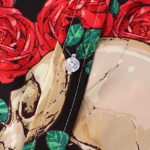 Detailed view of Halloween print shirt with red roses, skull patterns and pearl button.
