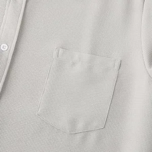 Close-up detail of a men's casual shirt pocket showing high-quality waffle texture fabric