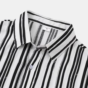 Close-up detail of a men's striped shirt collar featuring a vertical black and white pattern