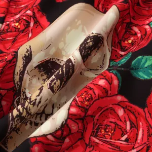 Close-up of Halloween shirt fabric with vibrant red roses and skull print design