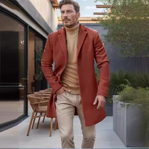 Elegant men's mid-length orange-brown woolen coat styled in a modern outdoor setting