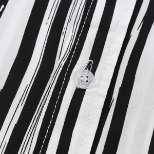 Detailed view showing the button and texture of black and white striped men's shirt