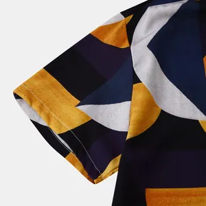 Close-up of the sleeve detail and abstract geometric print of a men's beach shirt.