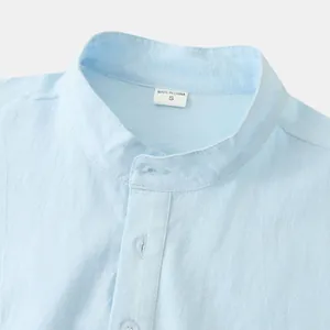 Close-up of a light blue mandarin collar on a breathable cotton linen shirt.
