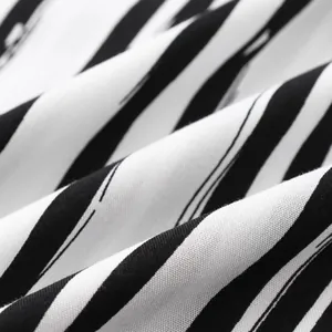 Close-up view of black and white striped fabric texture showing weave and soft folds.