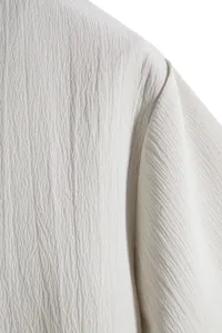 Macro view of the high-quality textured crinkle fabric on a men's summer shirt