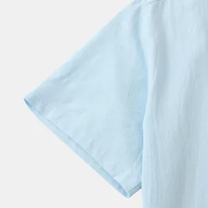 Close-up detail of light blue cotton linen men's short sleeve shirt showing fabric texture