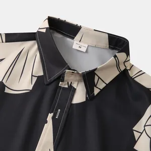 Dettaglio del colletto di una camicia a fiori da uomo con stampa astratta nera e beige