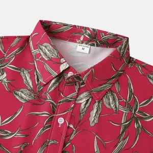 Detailed view of the collar and floral leaf print on a men's short-sleeve beach shirt.