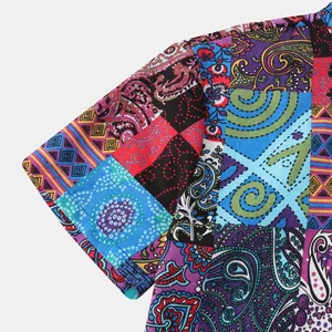 Detailed close-up of a men's shirt sleeve featuring vibrant colorful patchwork paisley patterns