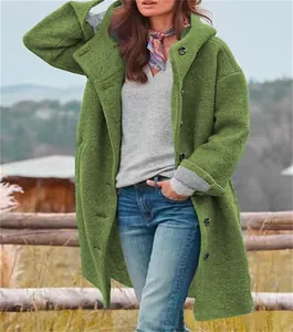 Detail view of a green textured hooded coat with single-breasted buttons in outdoor setting