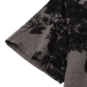Detailed macro shot of sleeve and fabric on men's floral print short-sleeve casual shirt