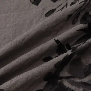 Close-up view of breathable grey fabric with black floral print pattern for men's casual shirt