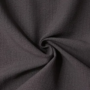 Professional close-up of dark grey men's shirt fabric with a subtle grid texture pattern.