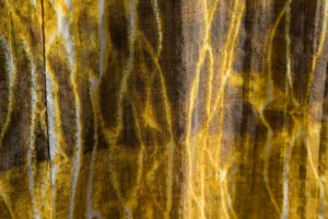 Close-up of tie-dye fabric texture on a men's casual floral short sleeve shirt.