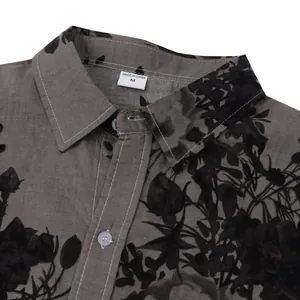 Close-up of a casual men's floral shirt collar with white contrast stitching details.