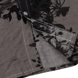 Close-up detail of men's floral shirt showing fabric texture and contrast stitching