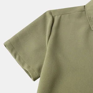 Detailed close-up view of the olive green waffle textured fabric on a men's short sleeve shirt