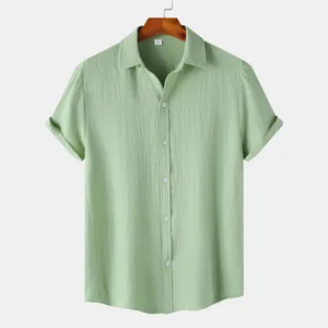 Detail view of light green men's short sleeve shirt with textured seersucker fabric