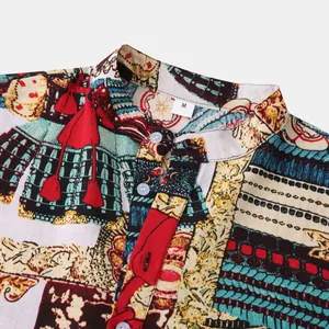 Close-up of men's Hawaiian shirt collar showing detailed ethnic print and linen texture.