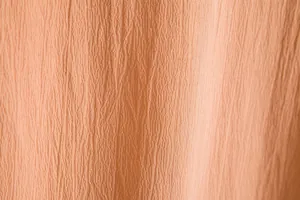 Macro detail of apricot textured fabric for men's summer short-sleeve button-down shirt