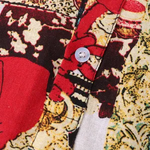 Close-up detail of vintage Hawaiian floral print fabric and white button on men's shirt
