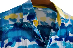 Close-up detail of a blue and yellow watercolor print men's short-sleeve casual shirt collar