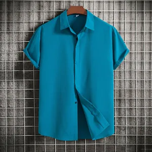 Front view of men's short-sleeved blue button-down shirt on a hanger with grid wall