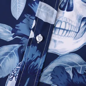 Close-up of Halloween skull and floral print on navy blue short sleeve shirt fabric